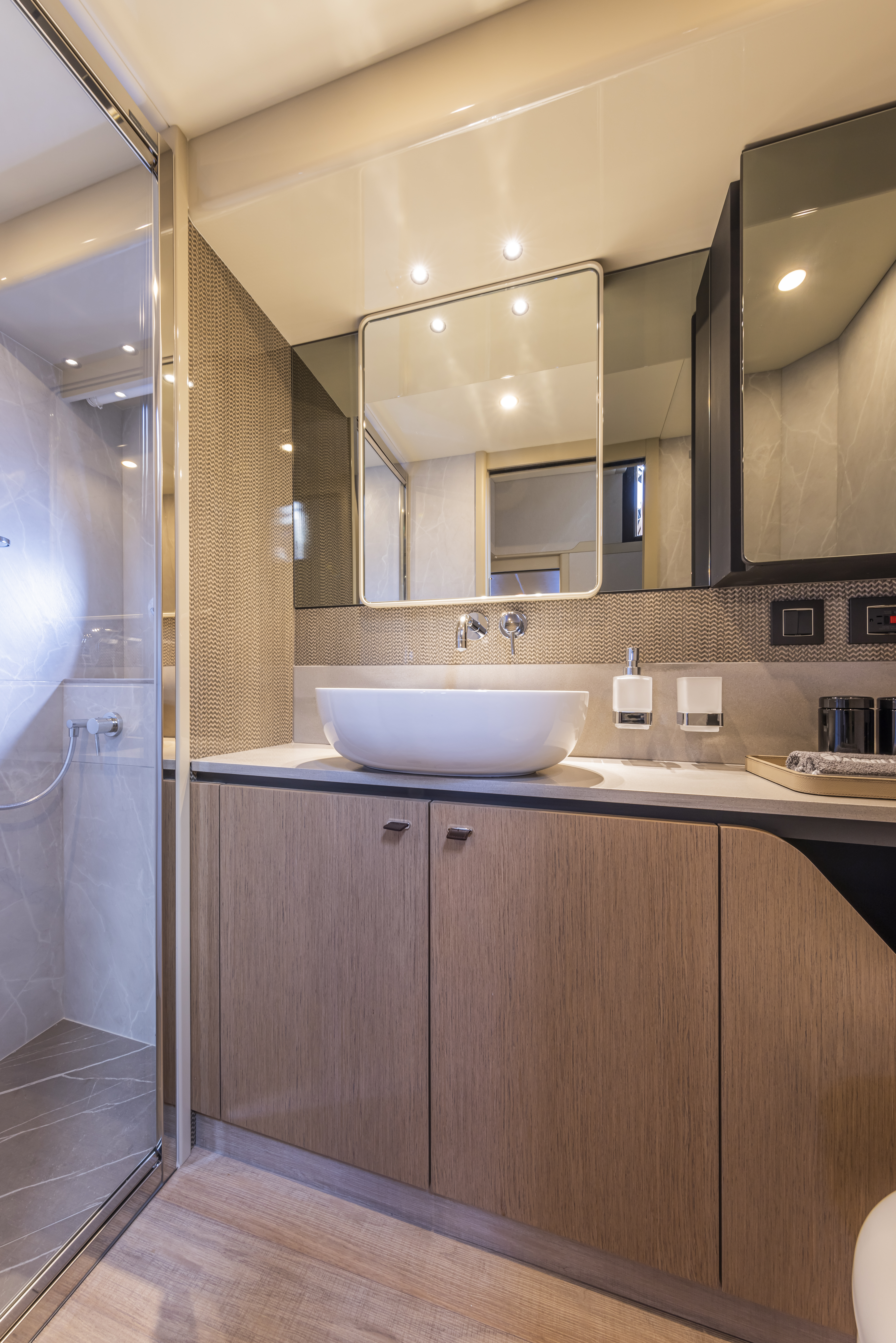56 FLY owner's cabin — king berth, vanity desk, hull windows at dusk