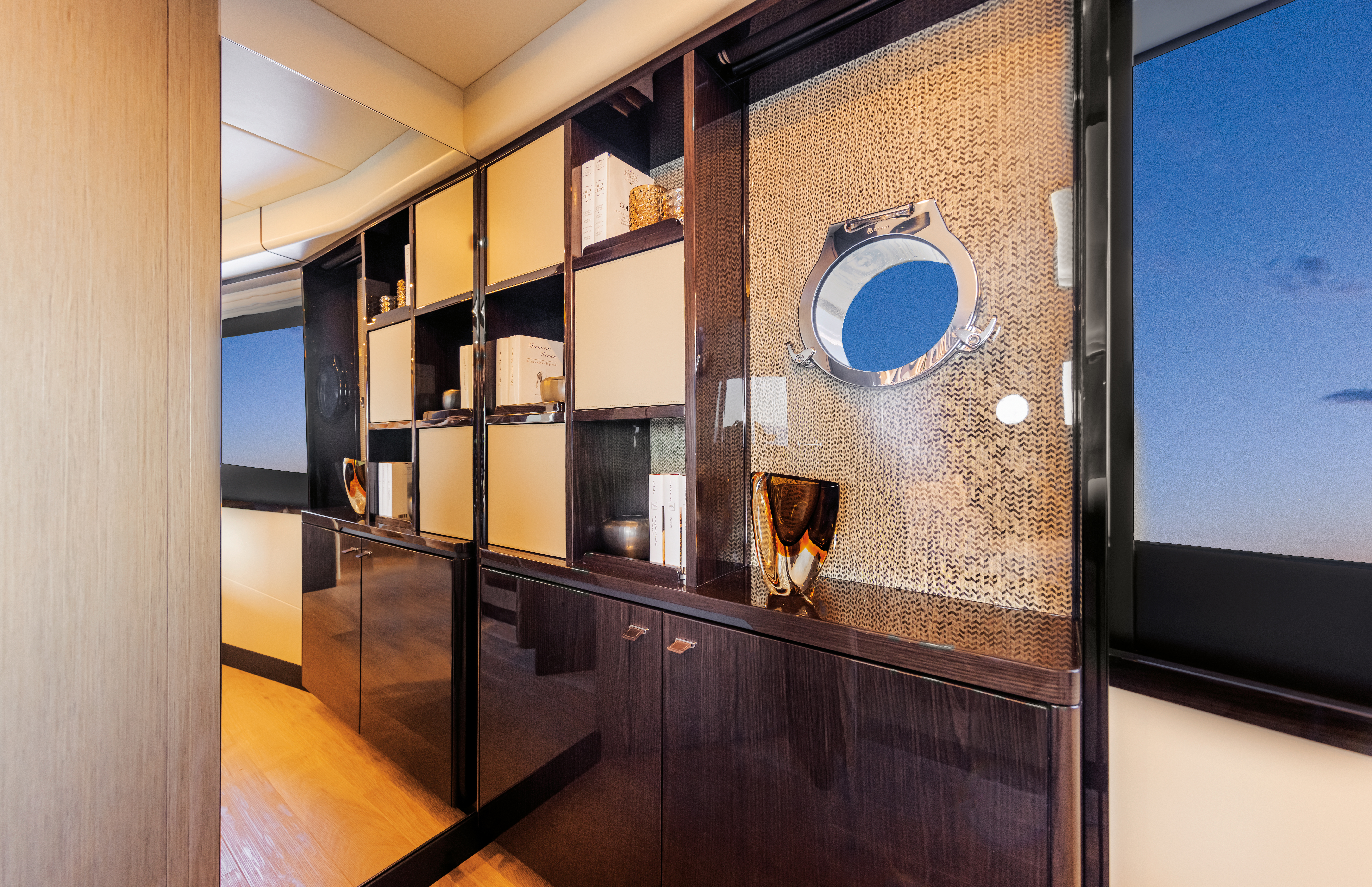 60 FLY owner's quarter at dusk — large hull window and vanity