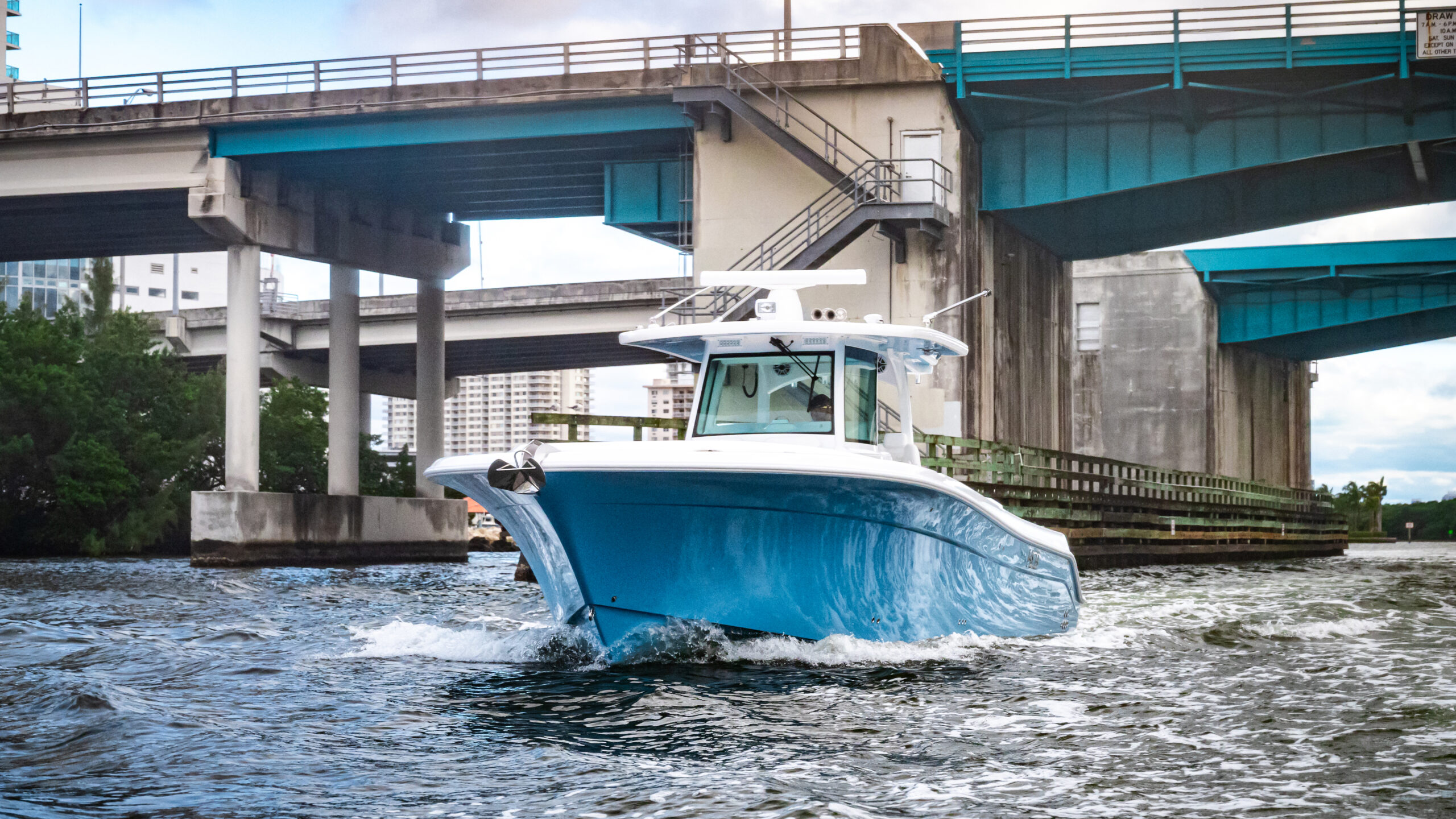 HCB 39 Speciale — full starboard profile, family aboard, mangrove backdrop