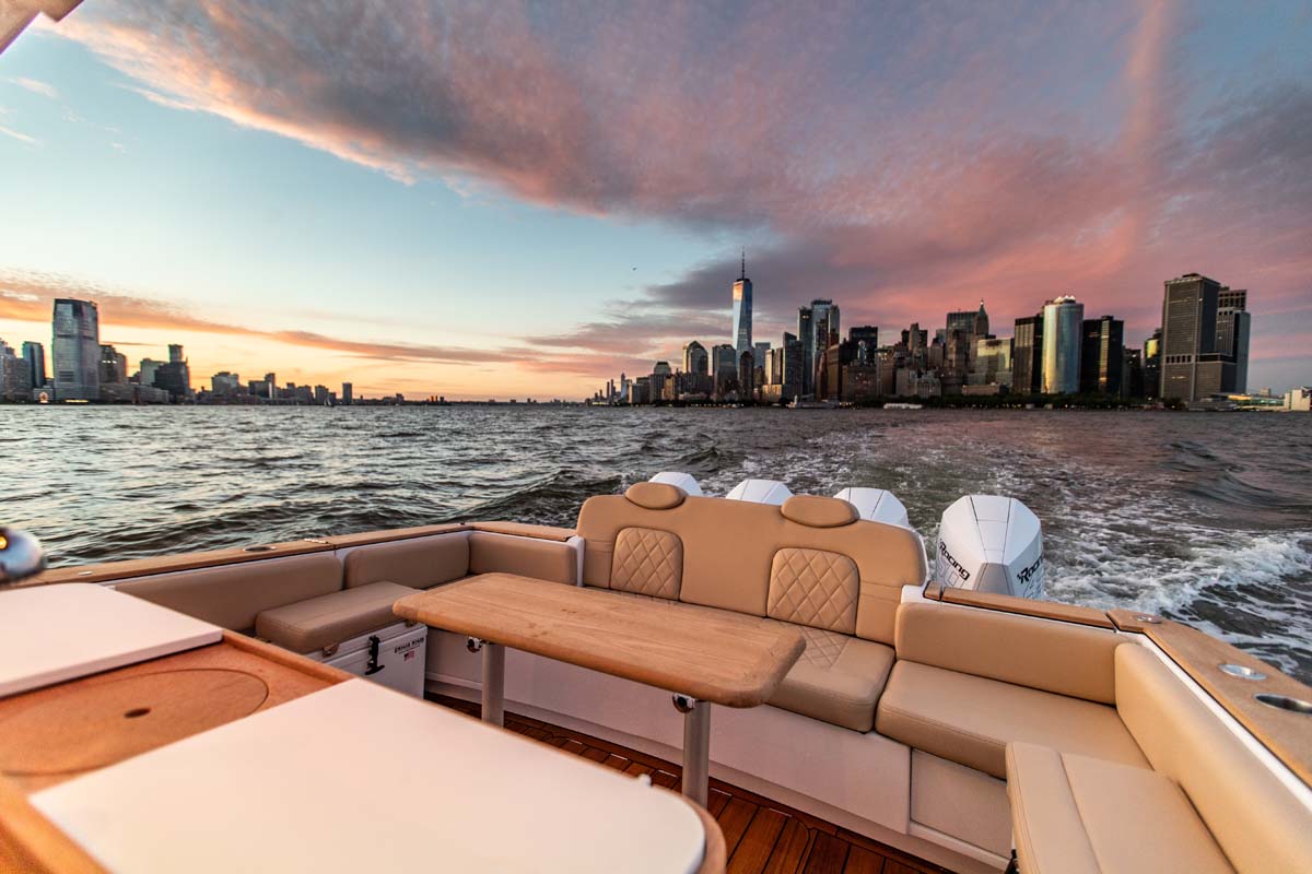 HCB 42 Lujo — white hull stern-on, triple Yamaha