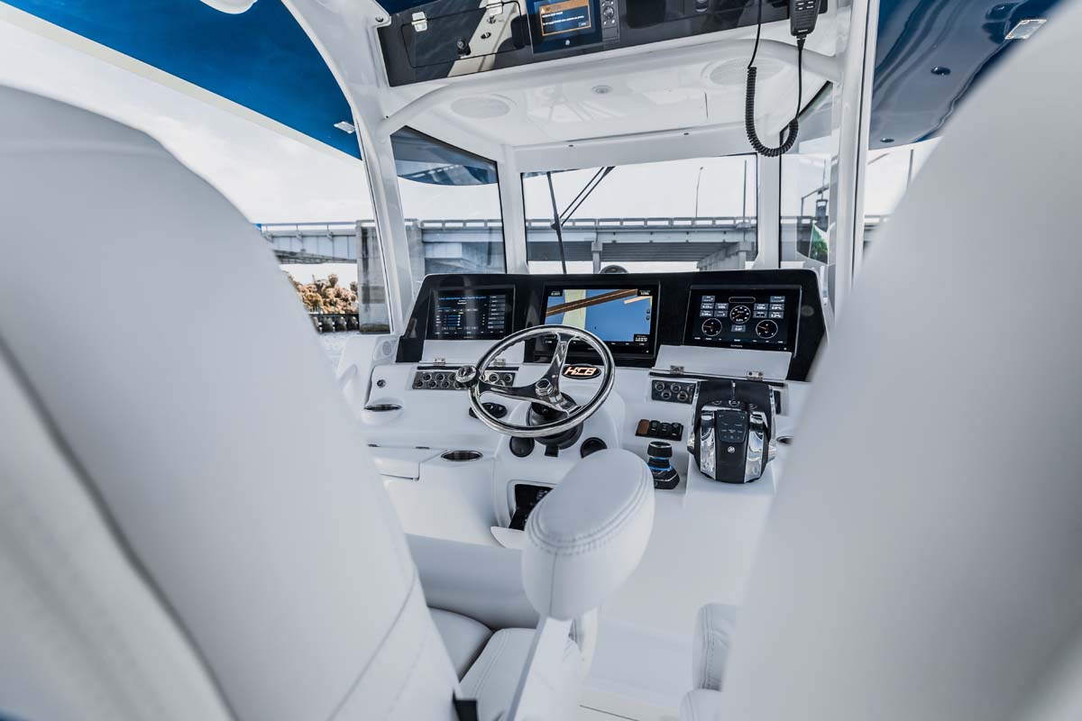 HCB 42 Lujo — cockpit aft lounge, teak sole, quilted seating
