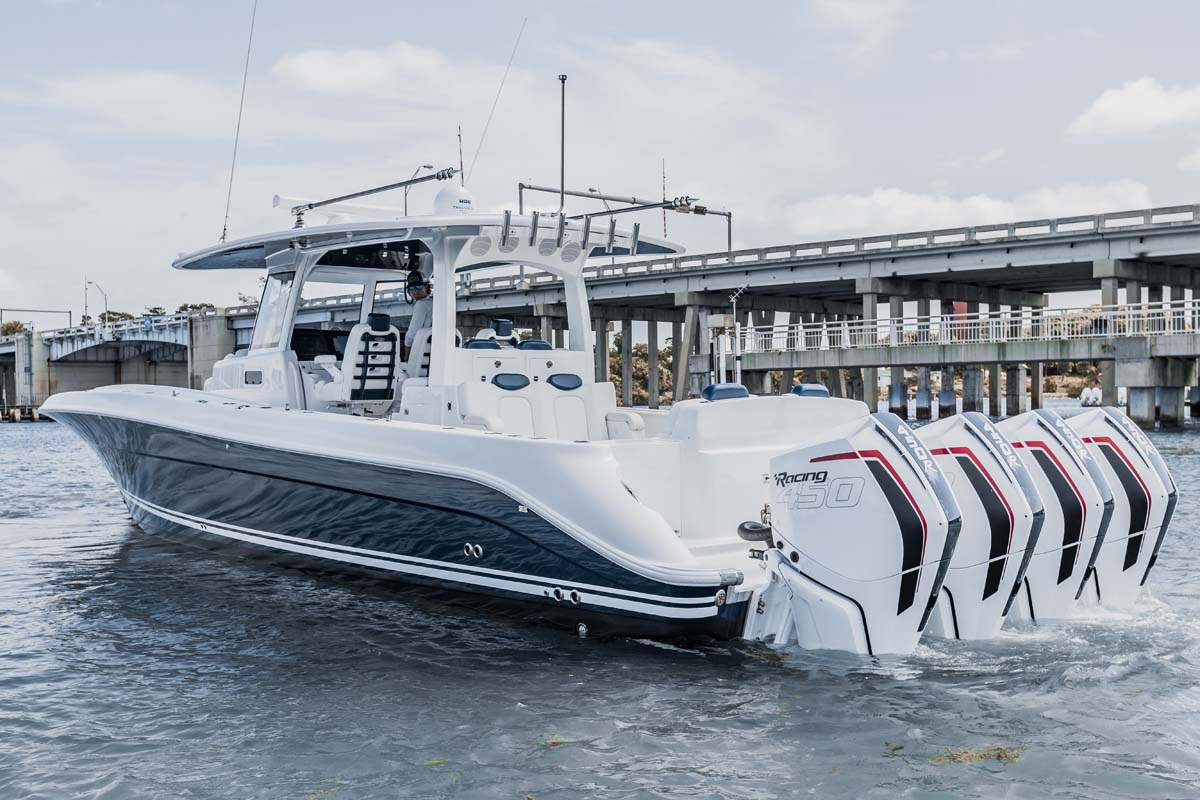 HCB 42 Lujo — navy hull bow quarter, quad Racing 450