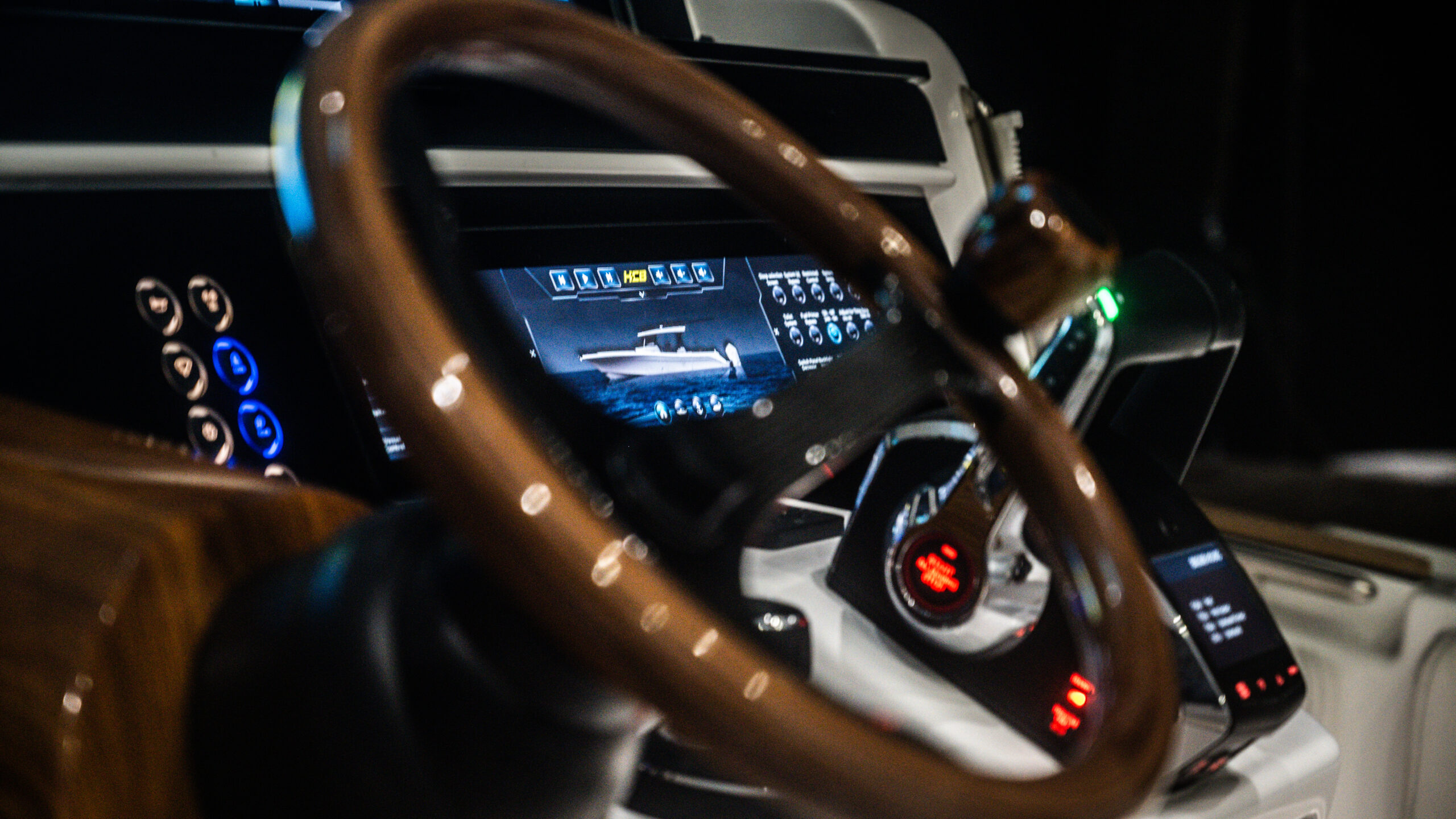 HCB 48 Campeón helm at night — walnut wheel, HCB digital display lit, systems screen
