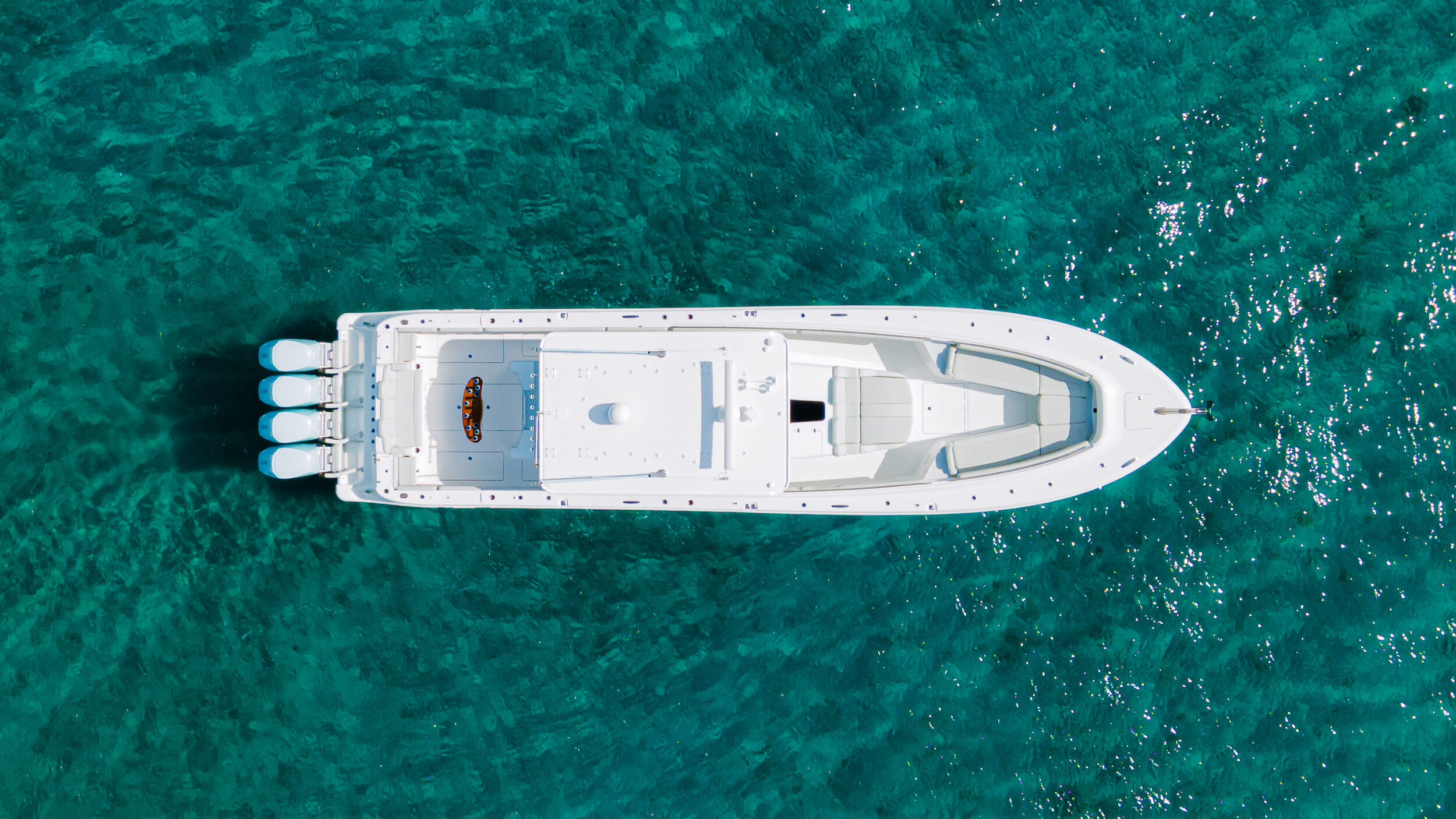 HCB 53 Sueños RXV — top-down aerial, turquoise Bahamas water, three outboards, full deck visible