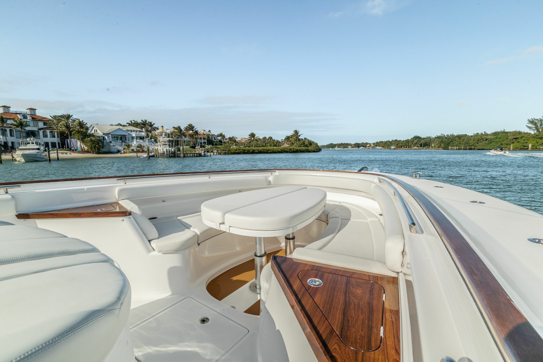 HCB 65 Estrella — starboard profile running, dramatic cloudscape, Palm Beach coastline