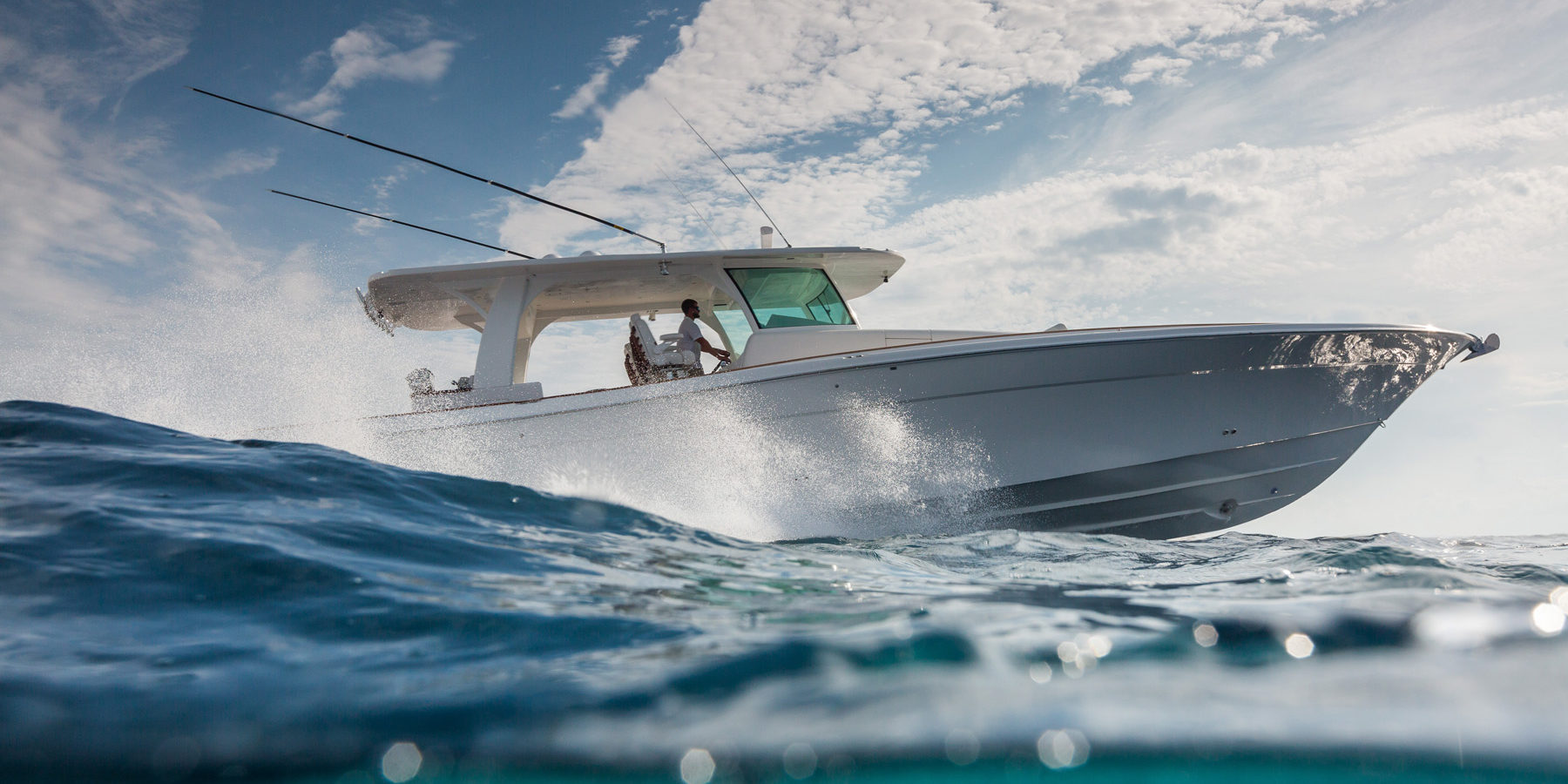 HCB 65 Estrella helm station — captain chairs row plus observer seating, blue hardtop, open sea