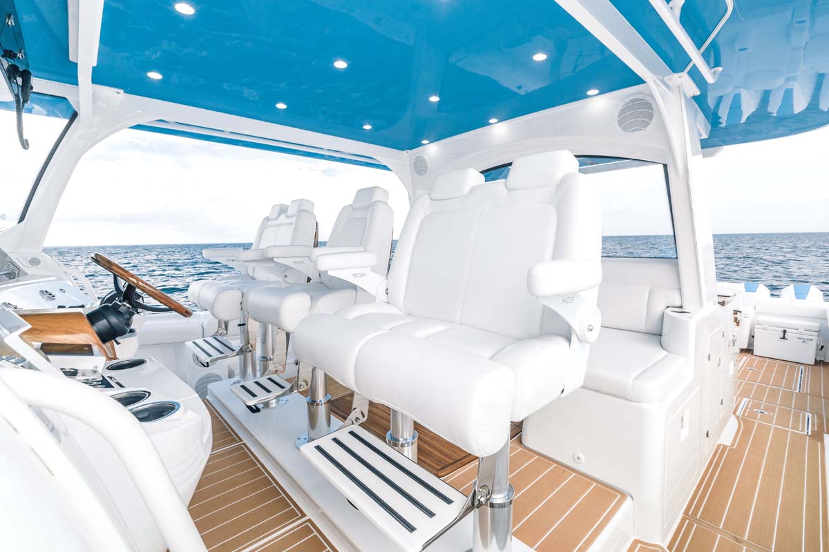 HCB 65 Estrella cockpit dining — teak HCB table set for six, teak captain chairs, intracoastal