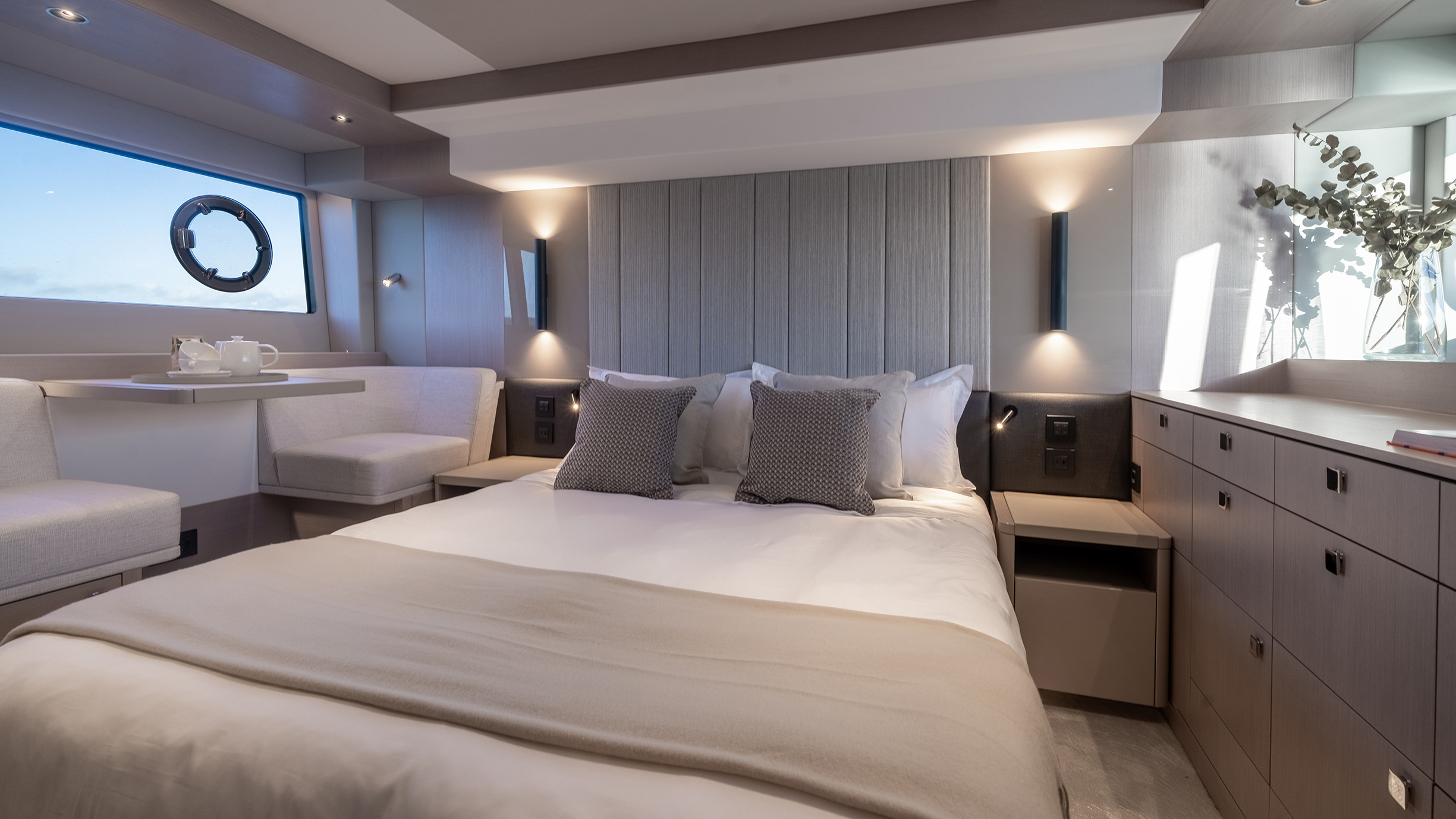 Sunseeker Manhattan 56 — master cabin wide, curved king bed, upholstered headboard, sitting area
