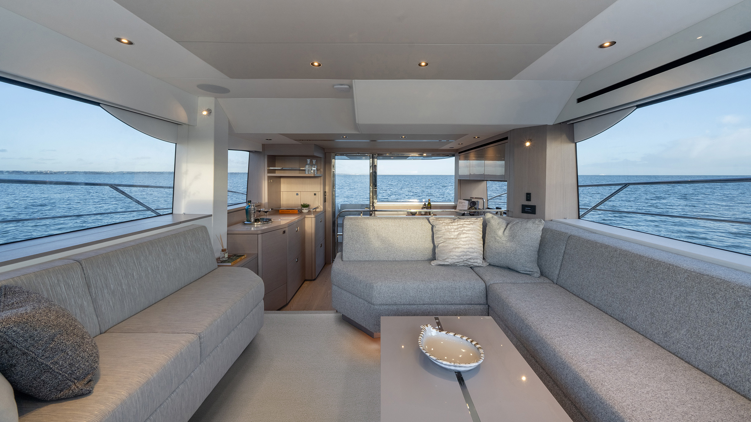 Sunseeker Manhattan 56 — saloon wide, panoramic windows both sides, galley beyond