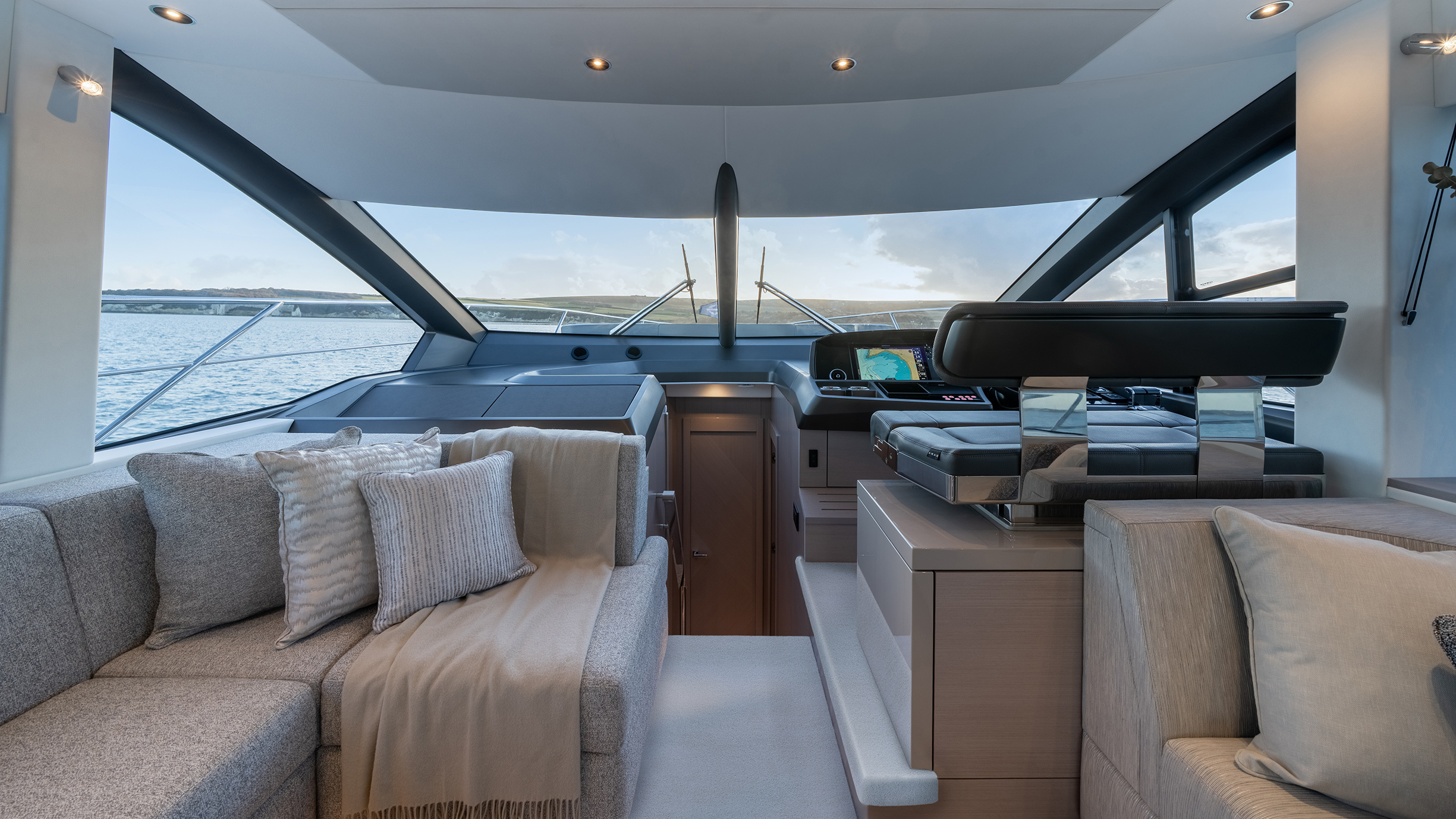 Sunseeker Manhattan 56 — main saloon looking forward, panoramic ocean glazing, grey sofas