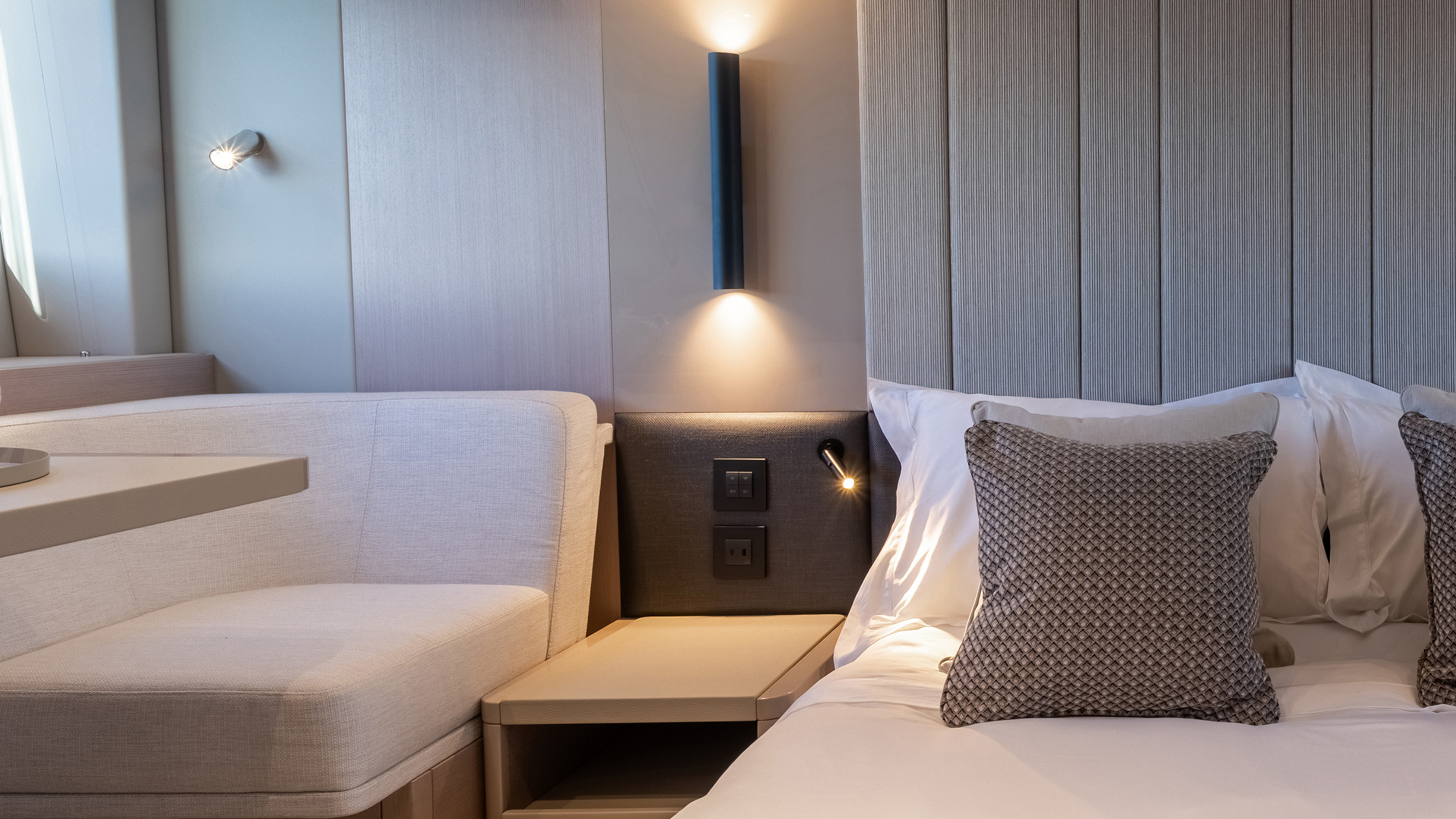 Sunseeker Manhattan 56 — master headboard and reading light detail close, textured upholstery