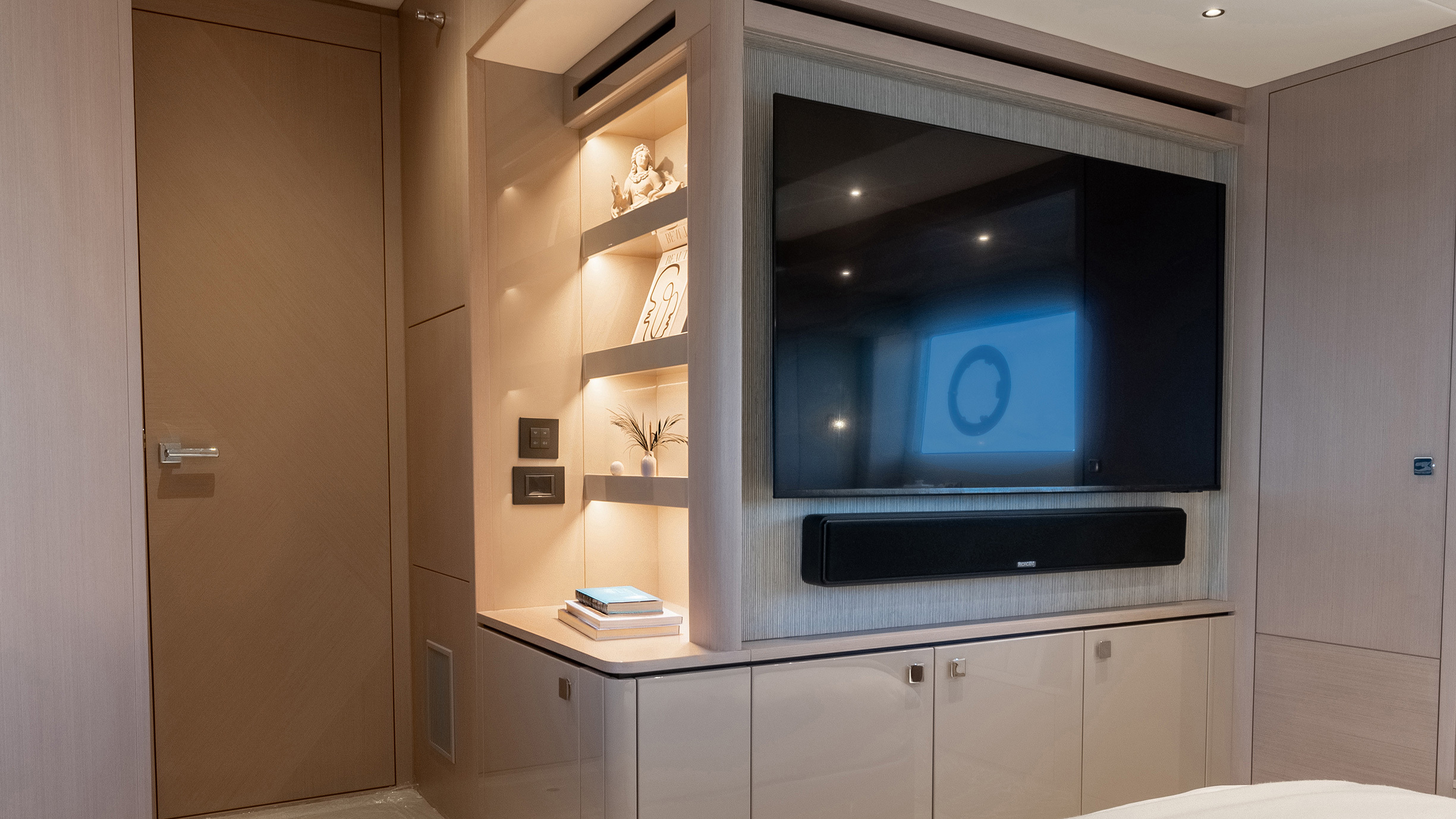 Sunseeker Manhattan 56 — master TV wall, illuminated display shelving, soundbar, cabinetry