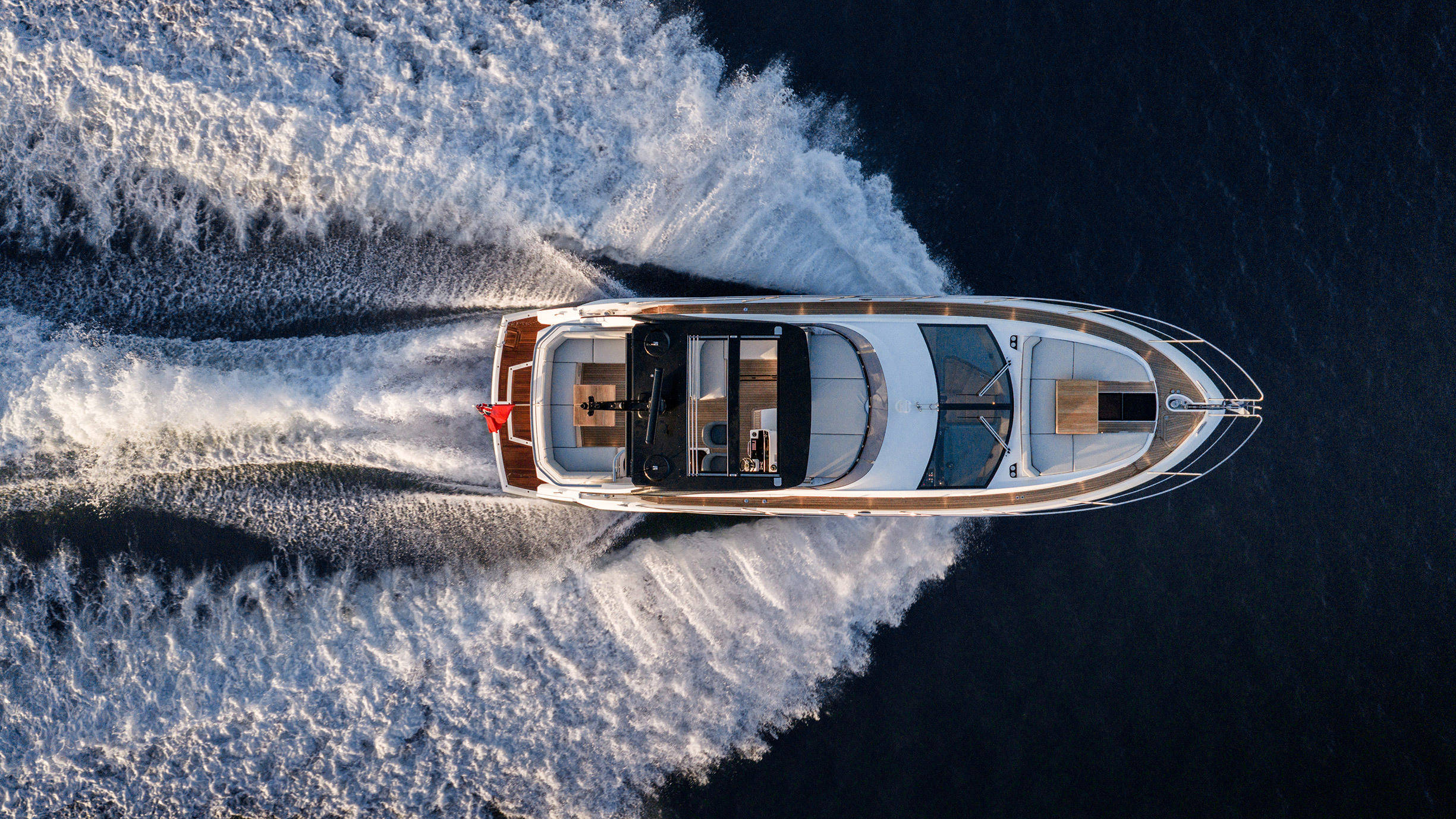 Sunseeker Manhattan 56 — starboard profile running hard, dusk, pink sky, Poole Harbour