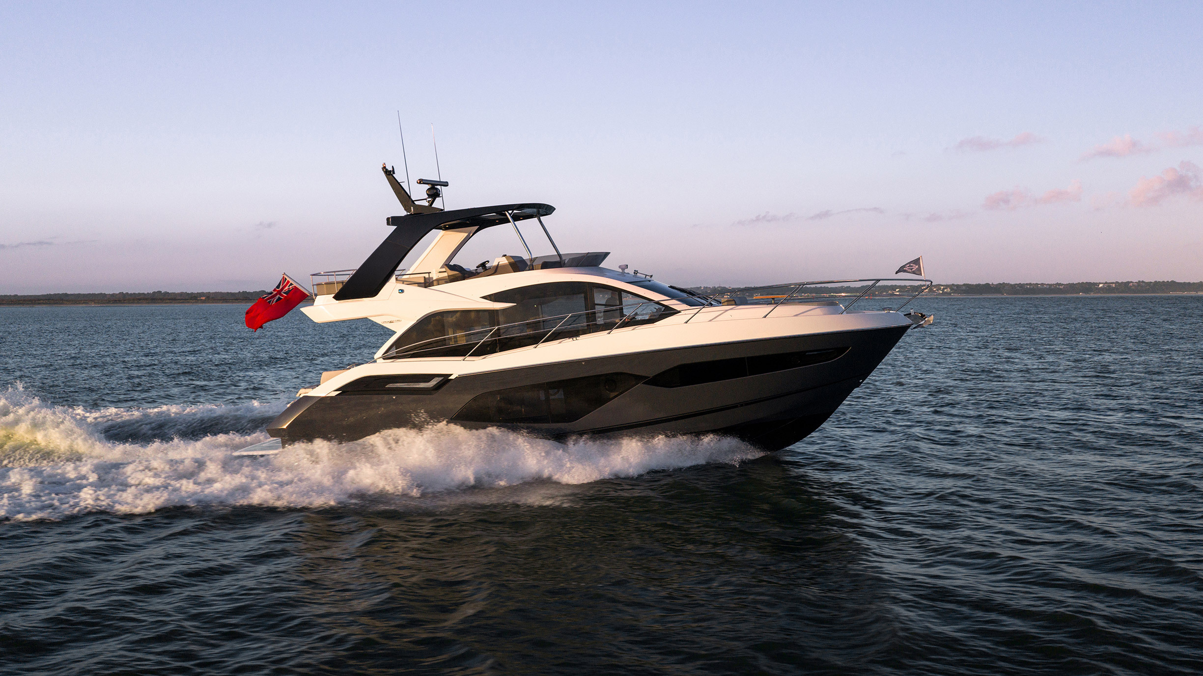 Sunseeker Manhattan 56 — aft quarter at sunset, Dorset hills, cockpit and flybridge