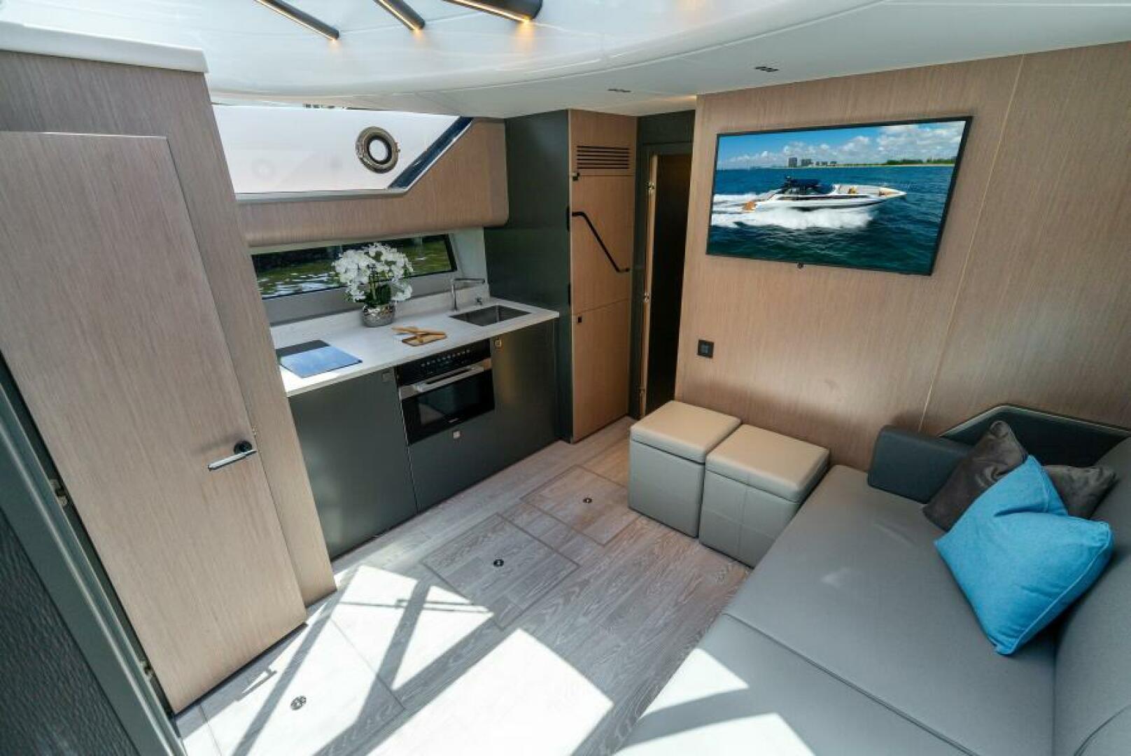 Sunseeker Superhawk 55 — below-deck saloon and galley, LED lighting, wood and lacquer finishes