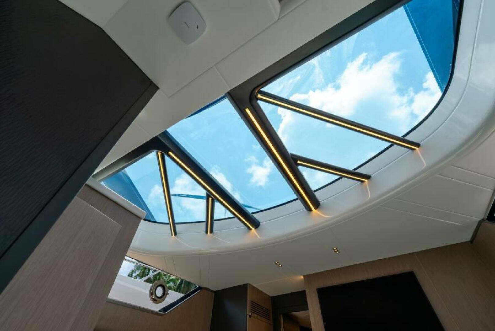 Sunseeker Superhawk 55 — glass roof skylight detail, LED lighting strips, blue sky