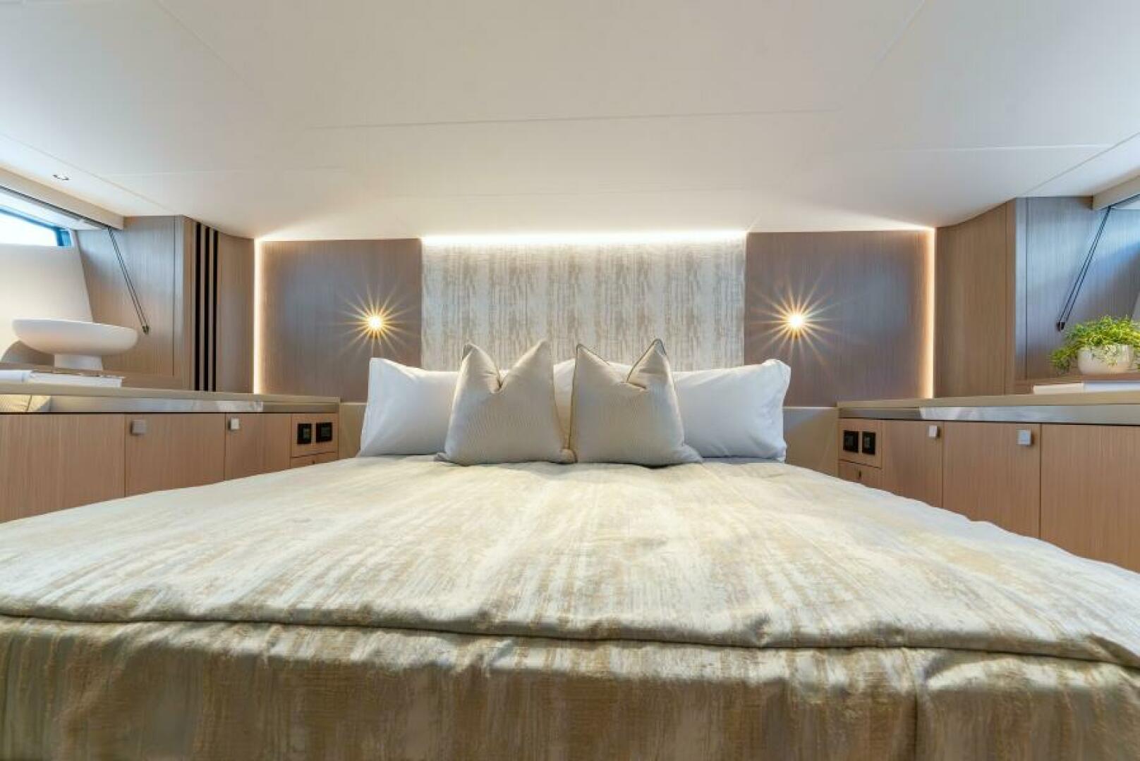 Sunseeker Superhawk 55 — VIP cabin face-on, double bed, upholstered headboard, twin accent lamps