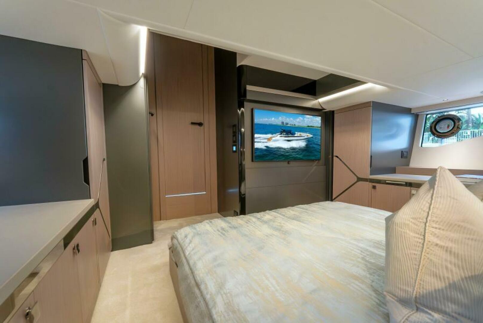 Sunseeker Superhawk 55 — master cabin wide, TV on black lacquer panel, wardrobe