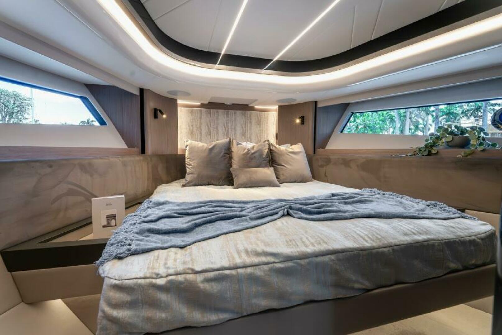 Sunseeker Superhawk 55 — master cabin face-on, LED ceiling halo, panoramic windows both sides