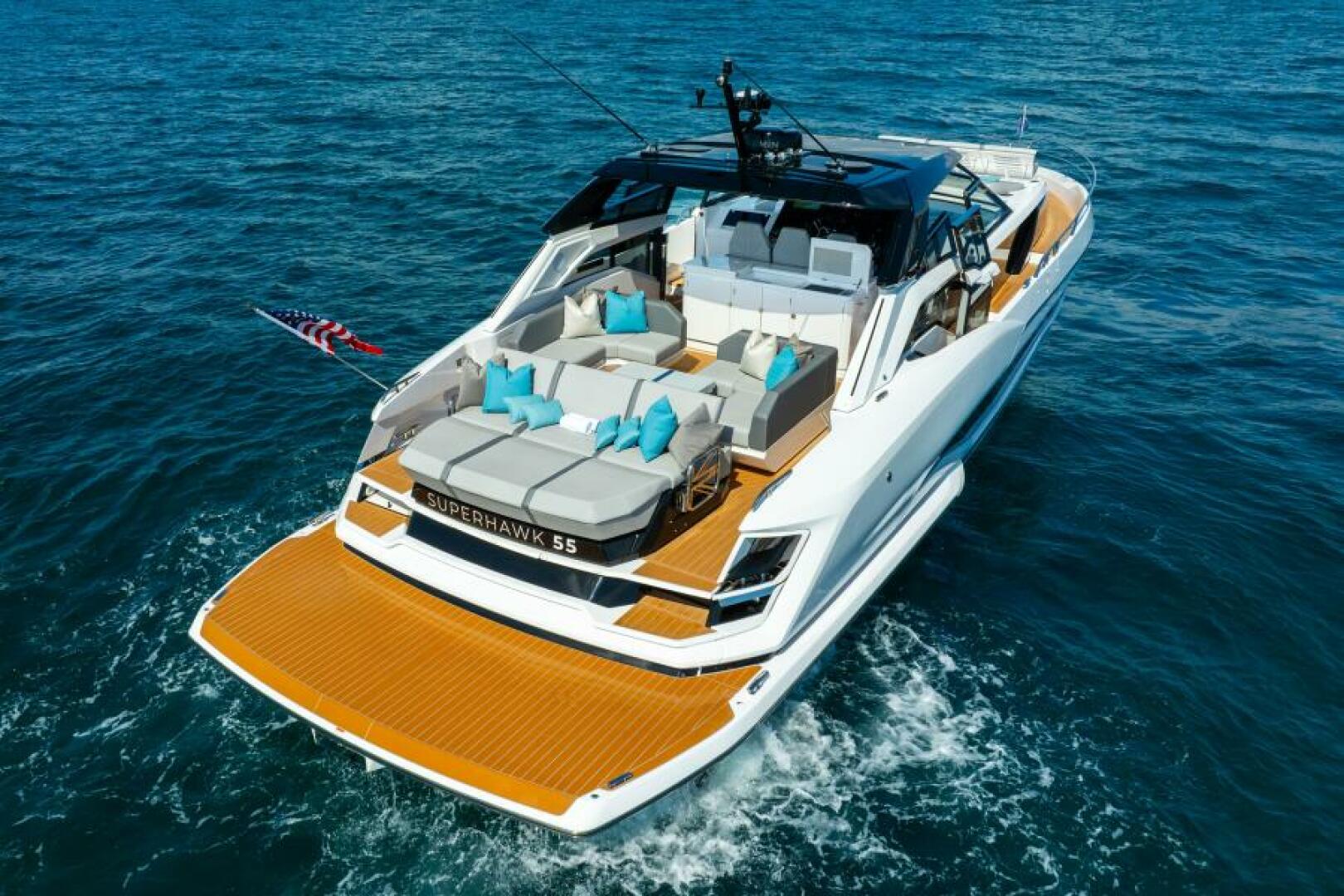 Sunseeker Superhawk 55 — aerial aft quarter, cockpit layout, teal accent pillows